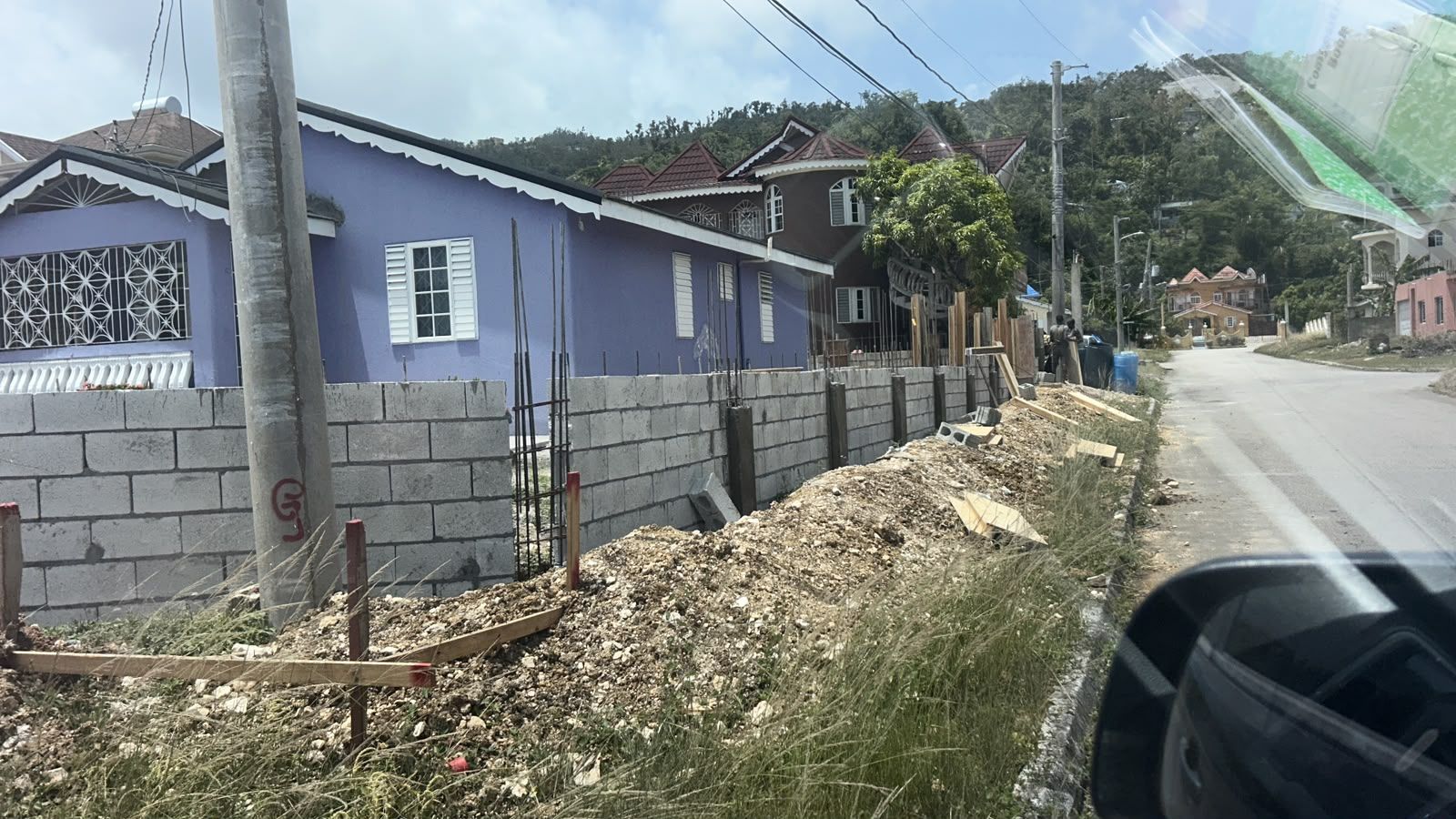 Concrete retaining wall construction along roadside