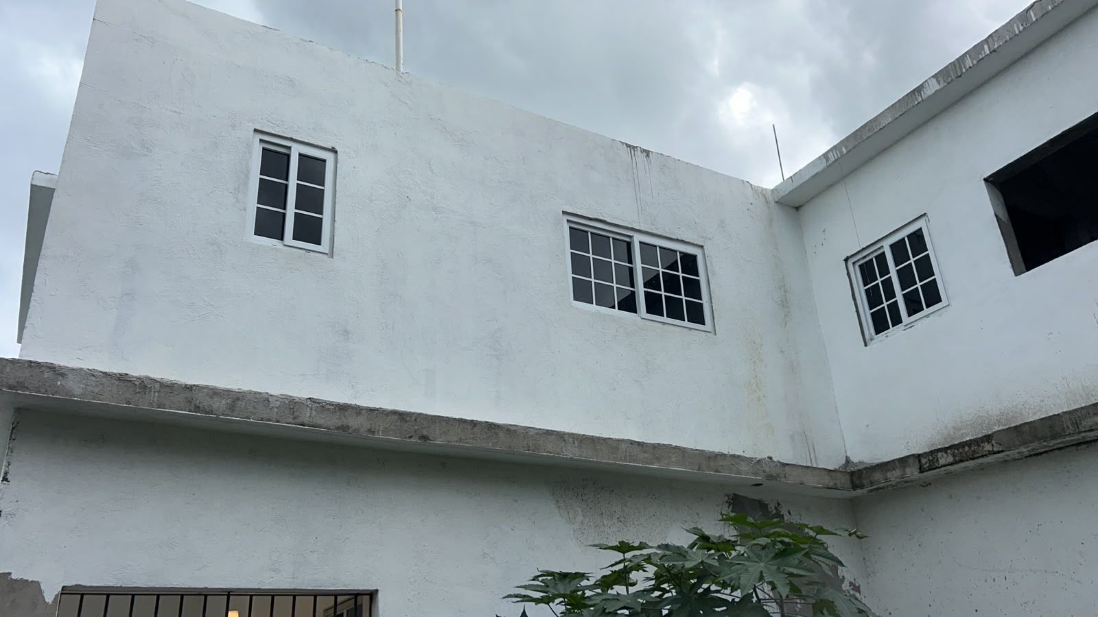 Plastered exterior wall with window installation