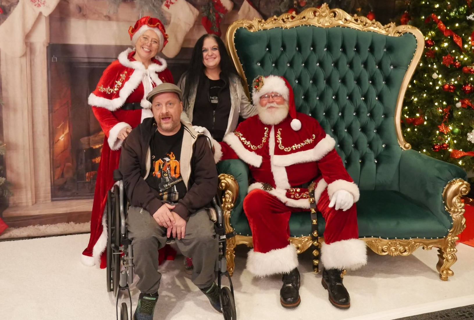 a group of people are posing for a picture with santa claus .