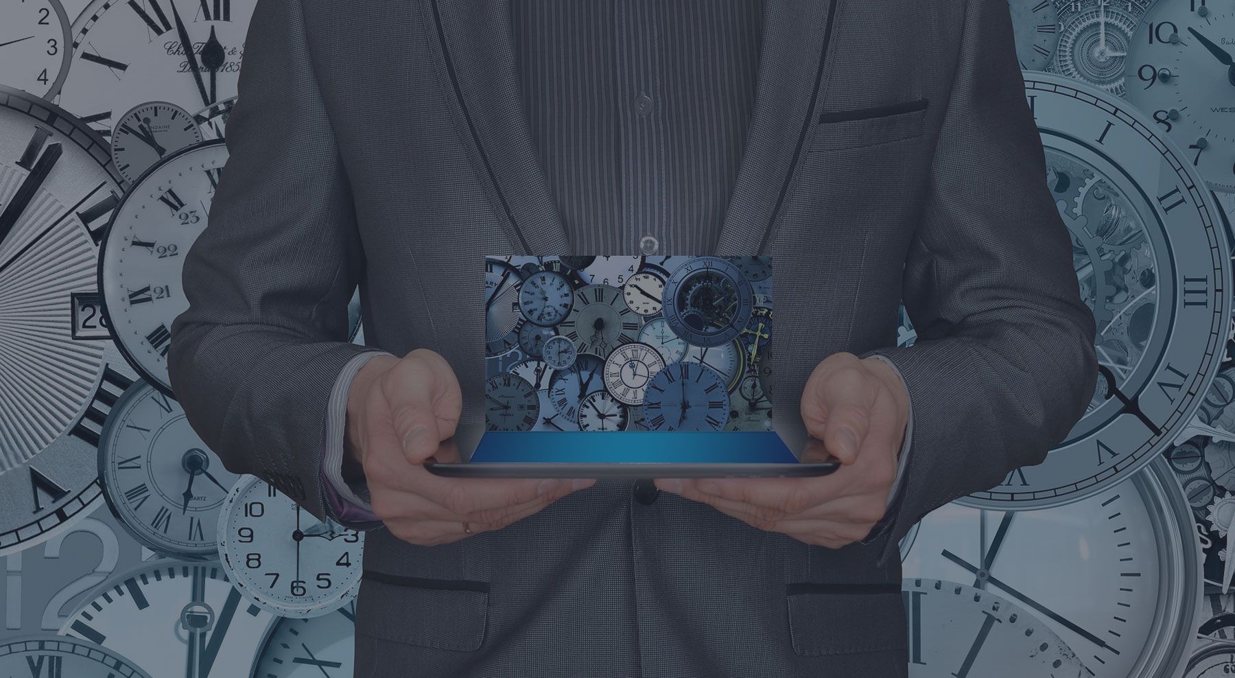 a man in a suit is holding a iPad with a picture of clocks on it.