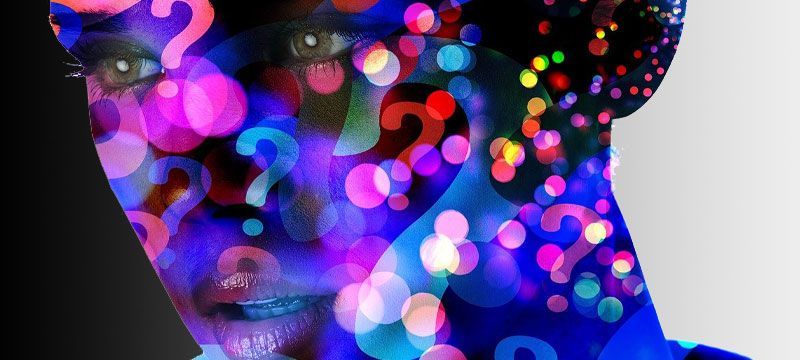 a woman 's face is surrounded by colorful question marks . a woman 's face is surrounded by colorful question marks .