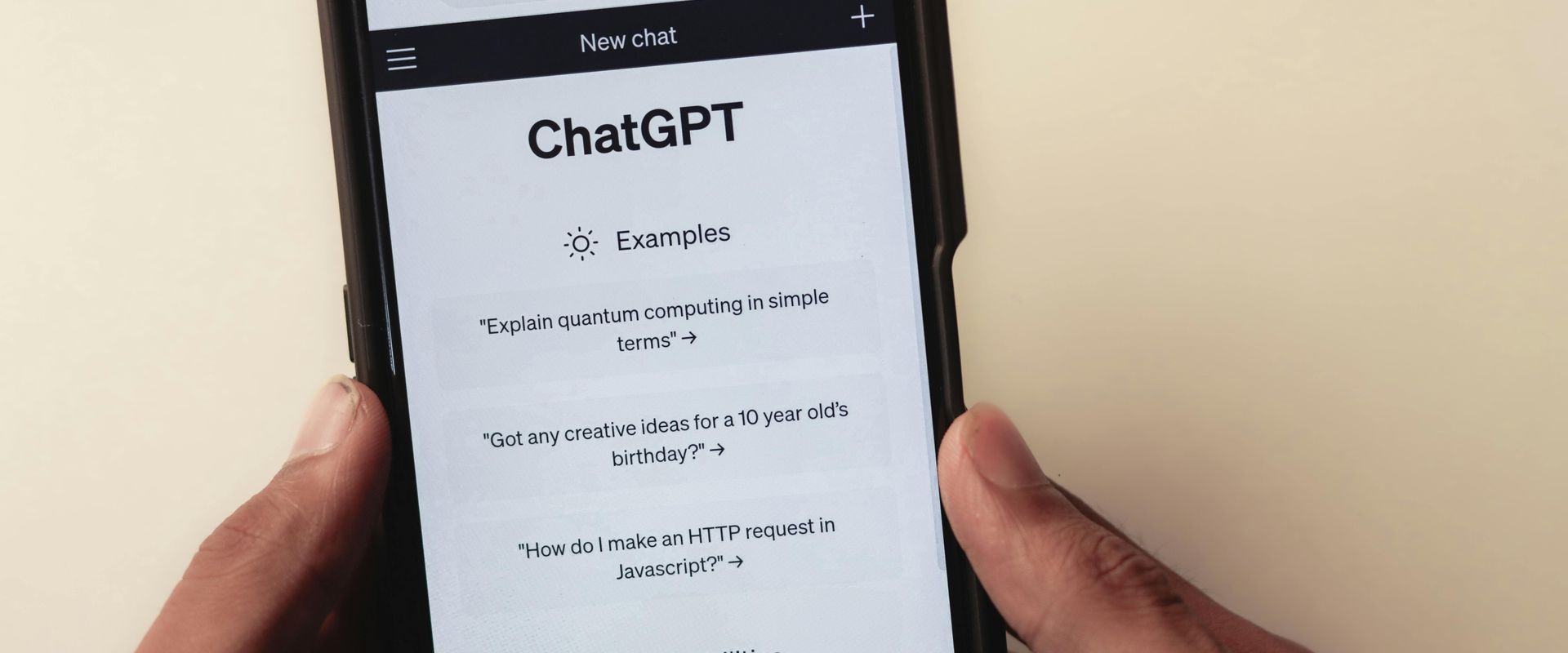 A person is holding a cell phone that says chatgpt on the screen.