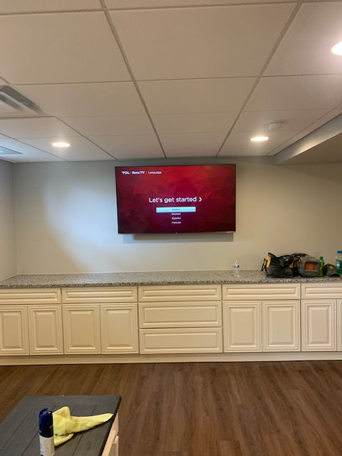 A wall-mounted TV showing a