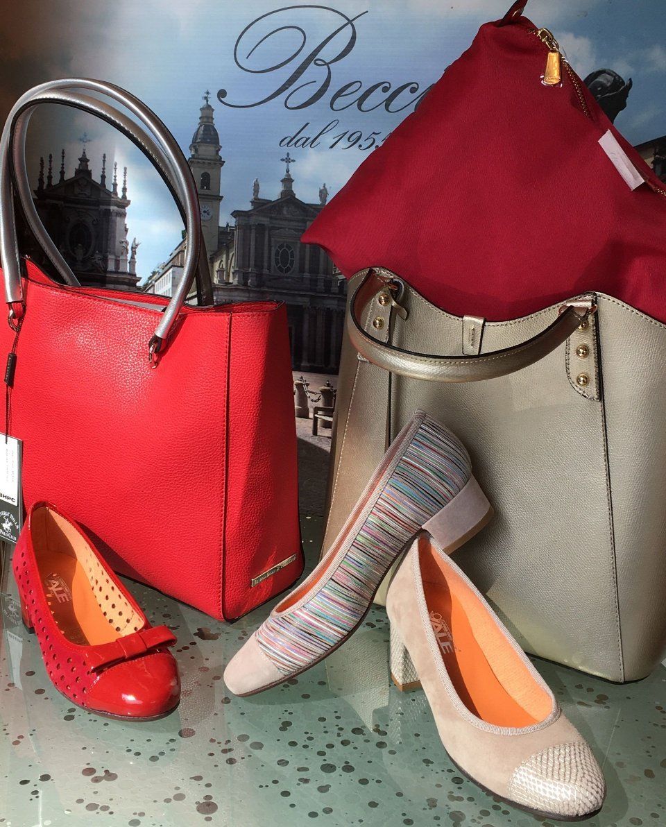 Borse e scarpe rosse e oro con sfondo fiorentino.