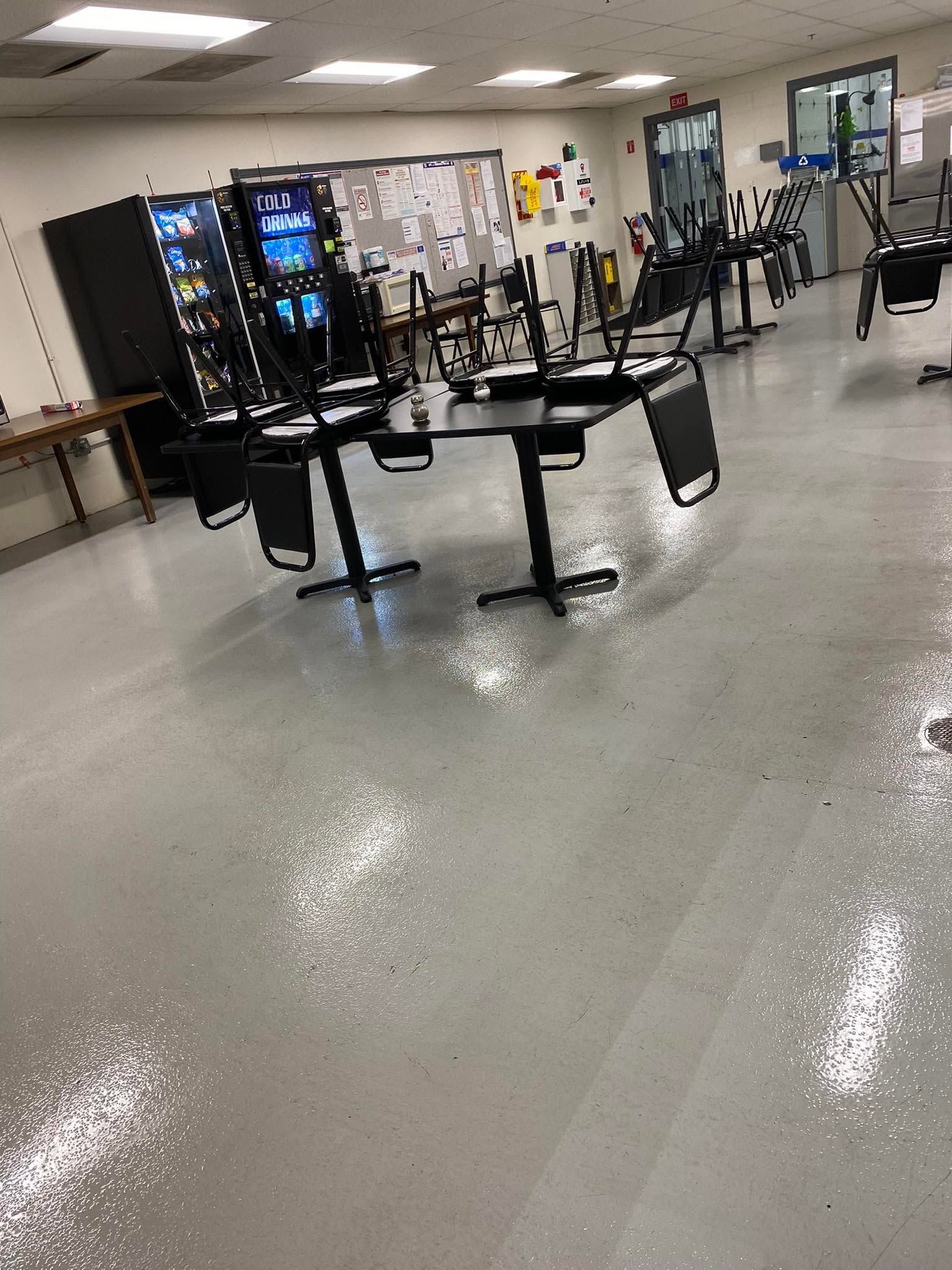 Indoor gym with exercise equipment and vending machines on a polished floor