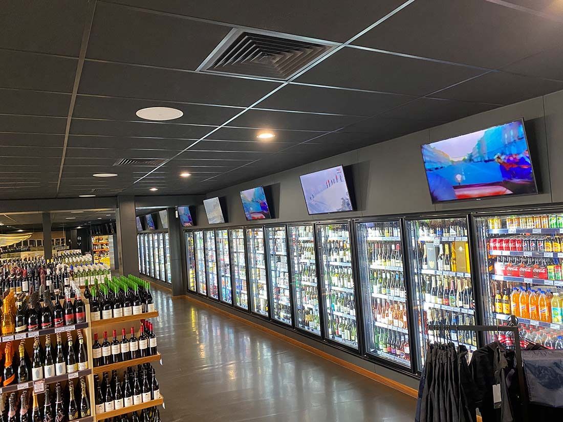 A Liquor Store Filled With Lots of Bottles and Coolers — Nauticool Refrigeration & Air Conditioning in Cannonvale, QLD