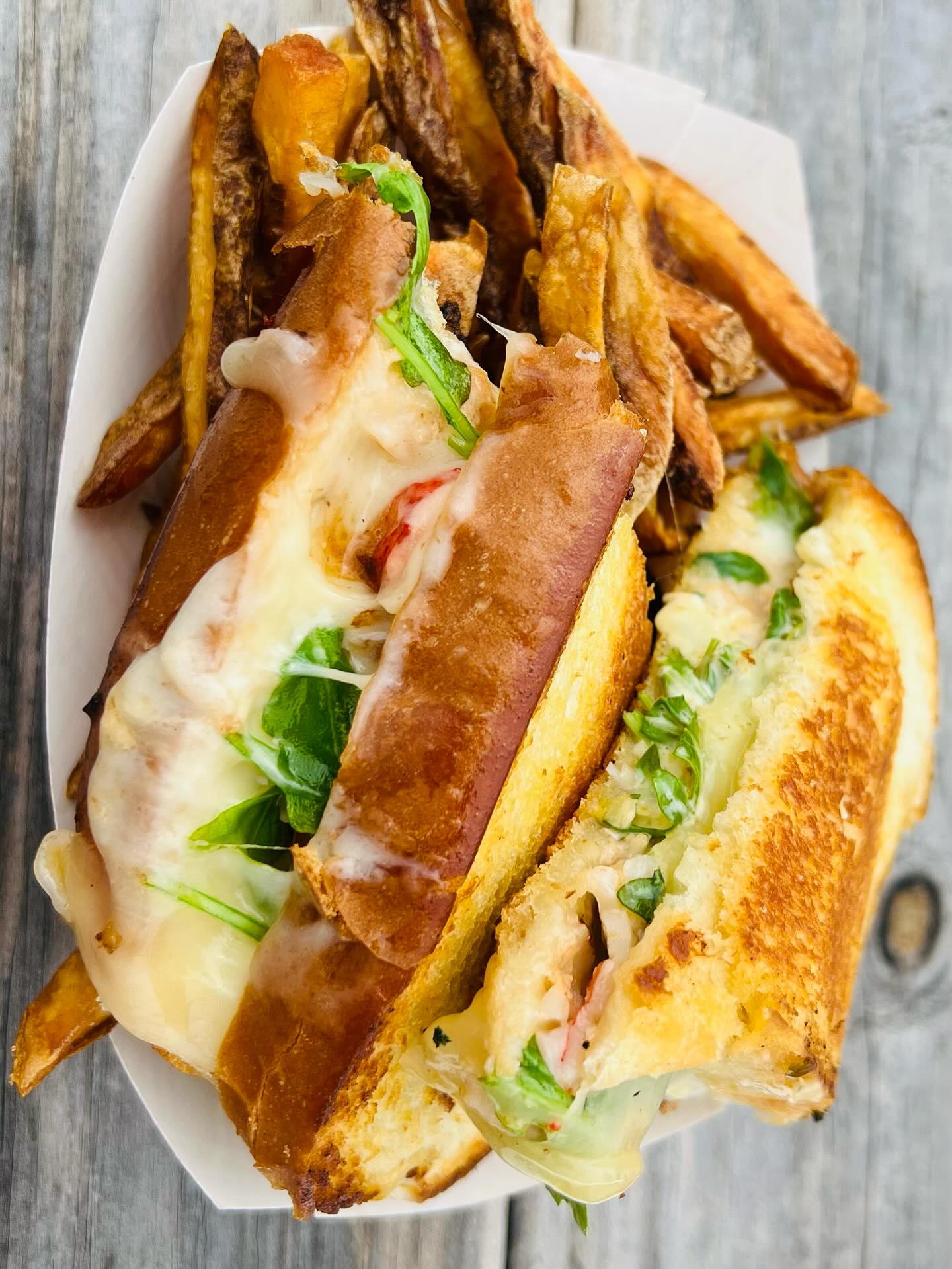 Lobster grilled cheese sandwich with arugula, two hushpuppies.