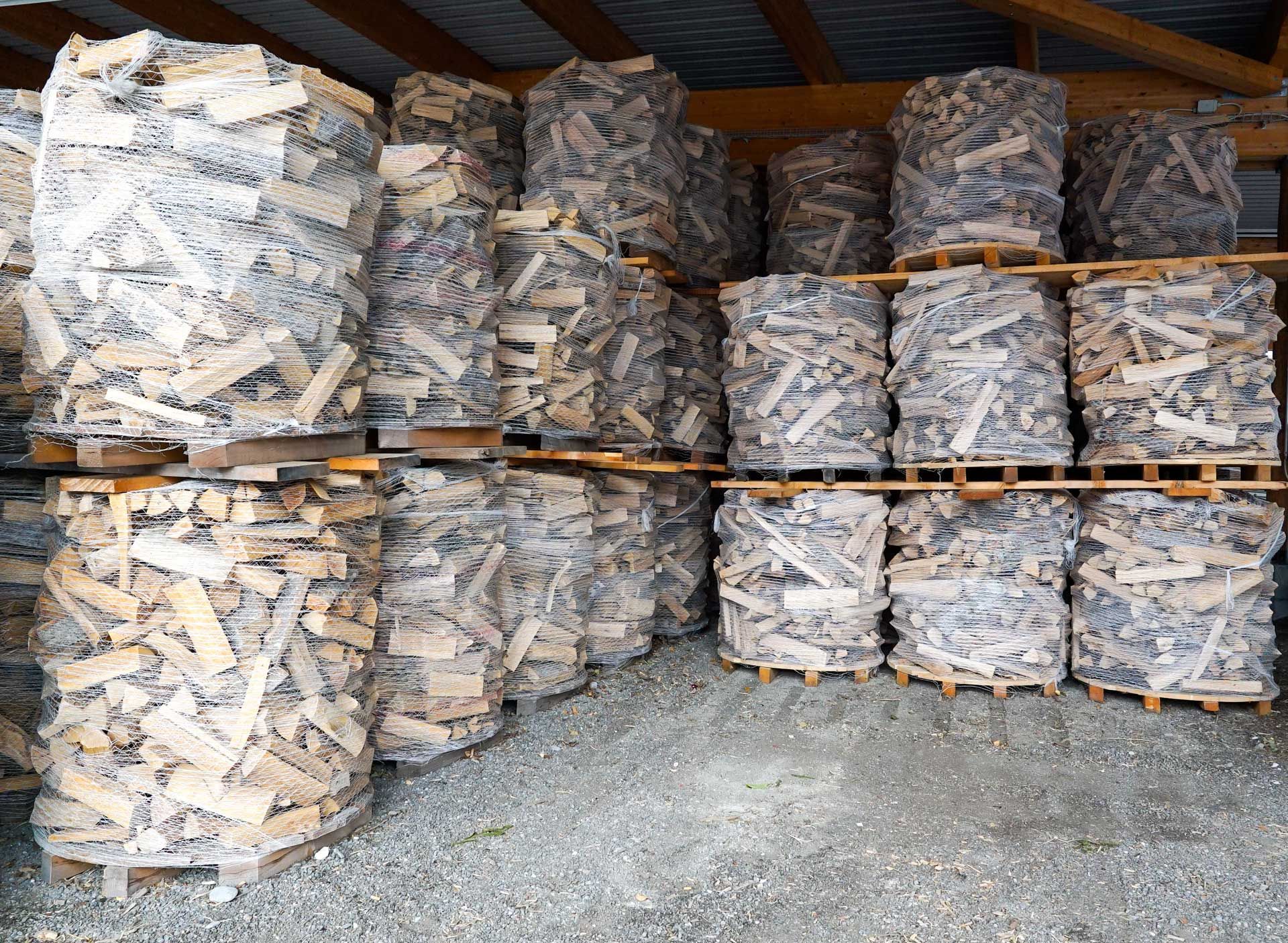 A bunch of bags of wood are stacked on top of each other A bunch of bags of wood are stacked on top of each other