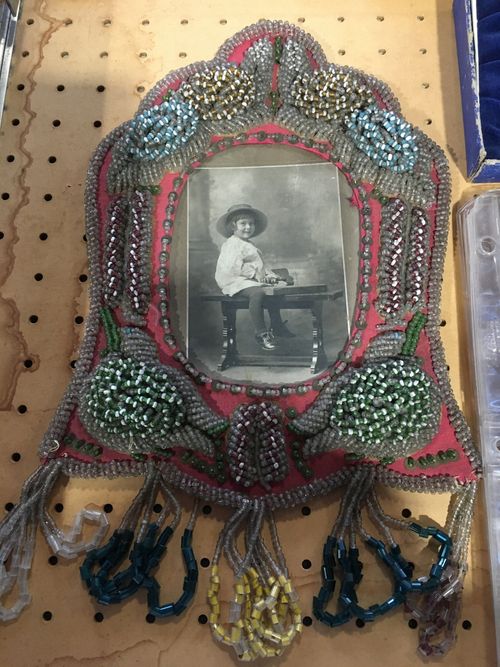 A framed picture of a boy in a cowboy hat