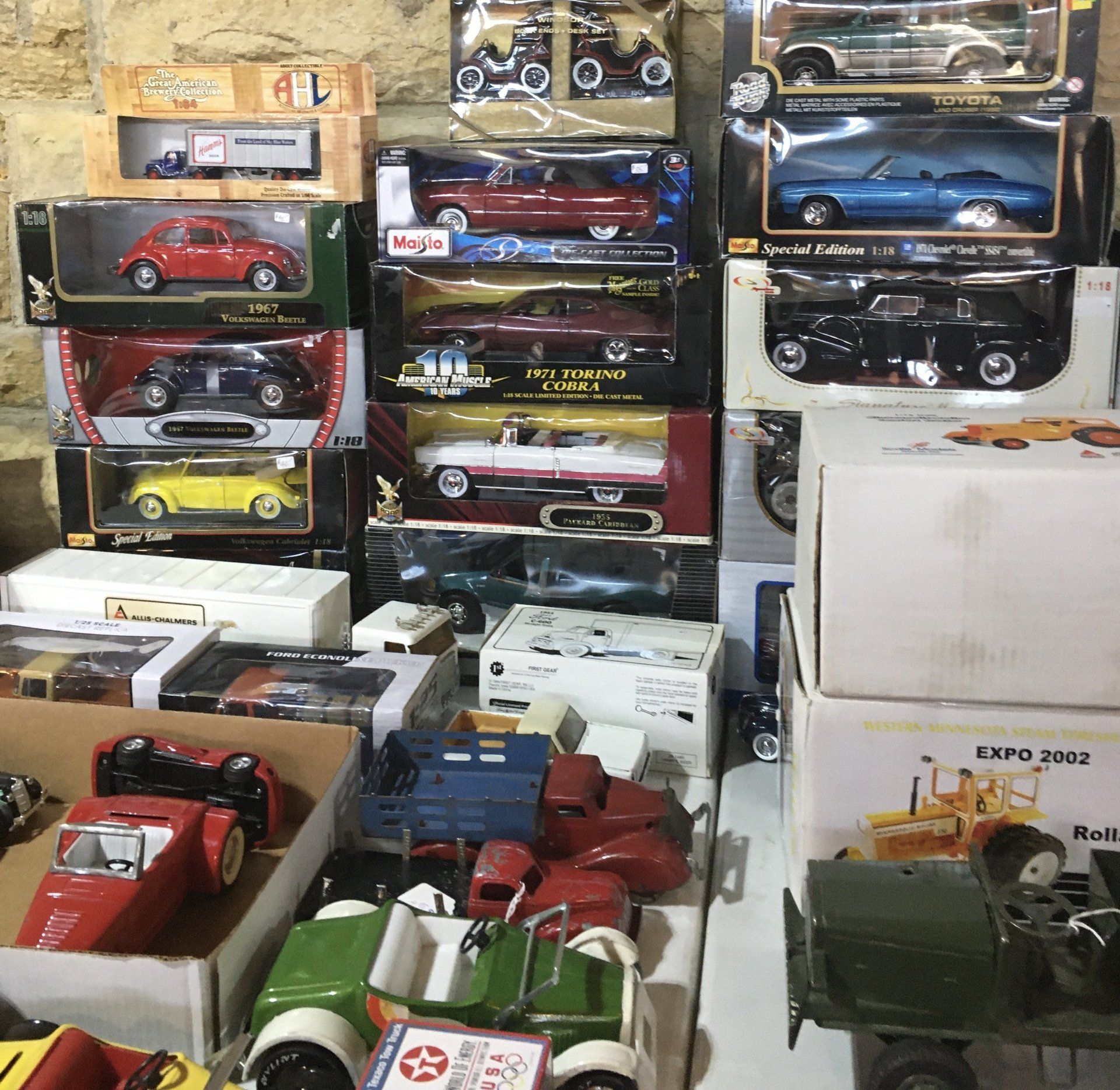 A bunch of toy cars are stacked on top of each other