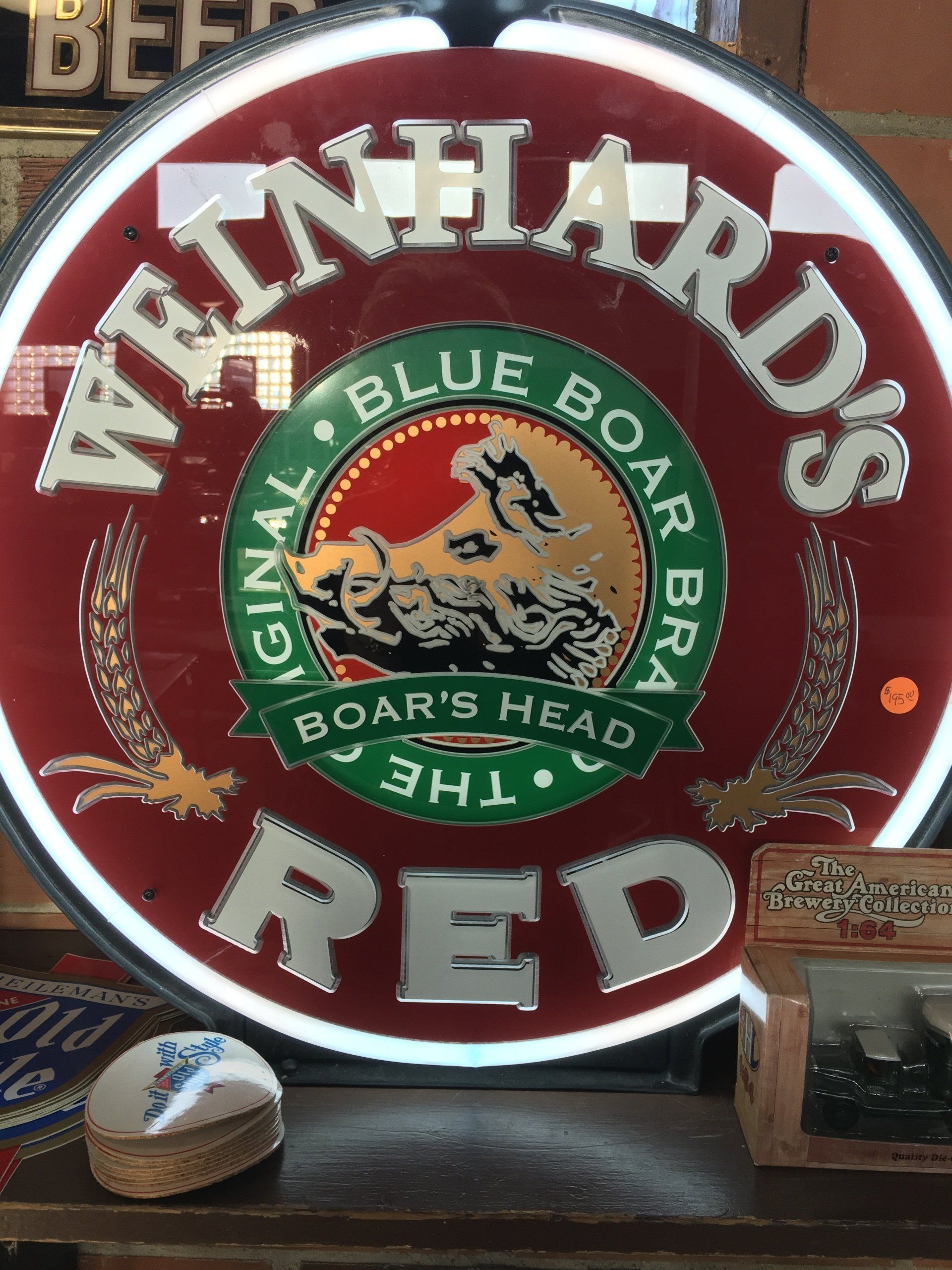 A neon sign for weinhard 's blue boar 's head red