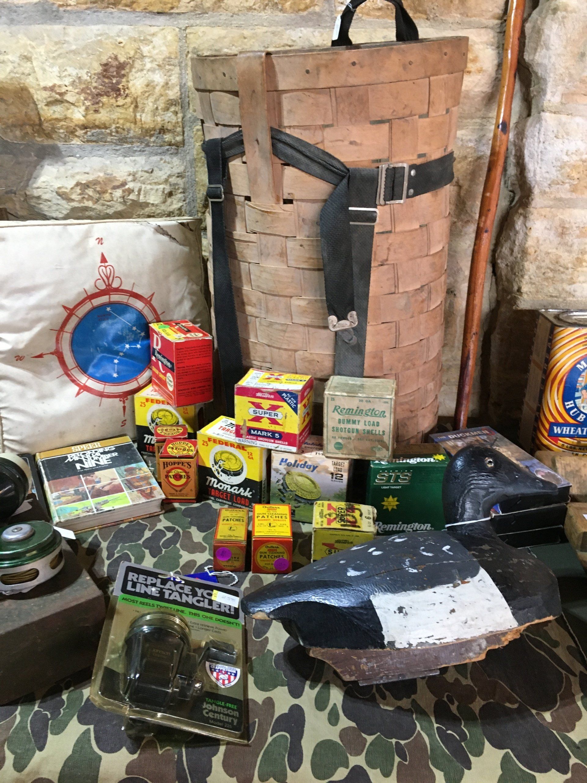 A bunch of toys are sitting on a table next to a brick wall.