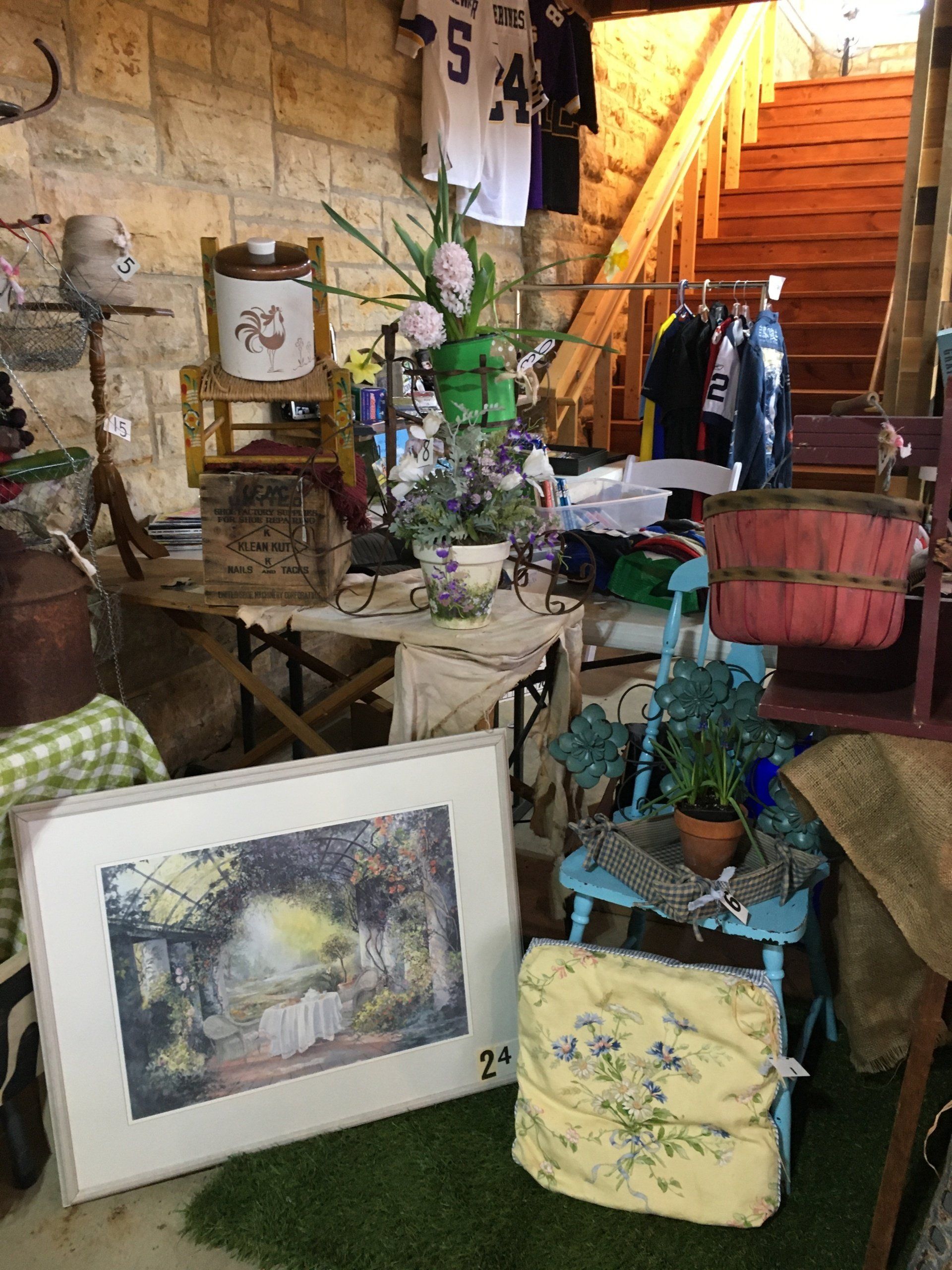 A room filled with lots of furniture and a painting on the floor.