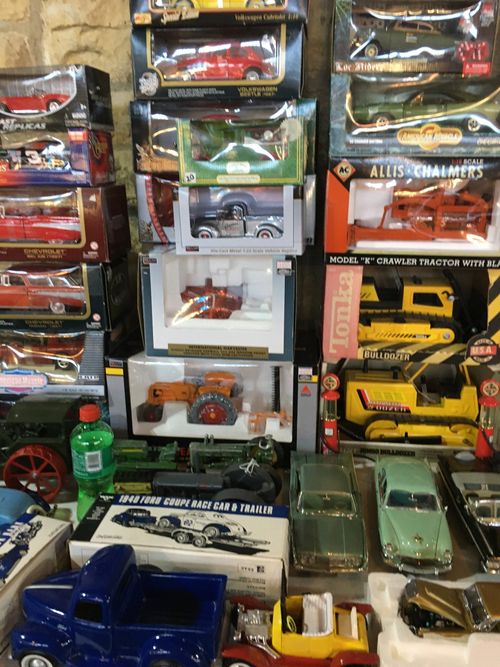A bunch of toy cars are stacked on top of each other