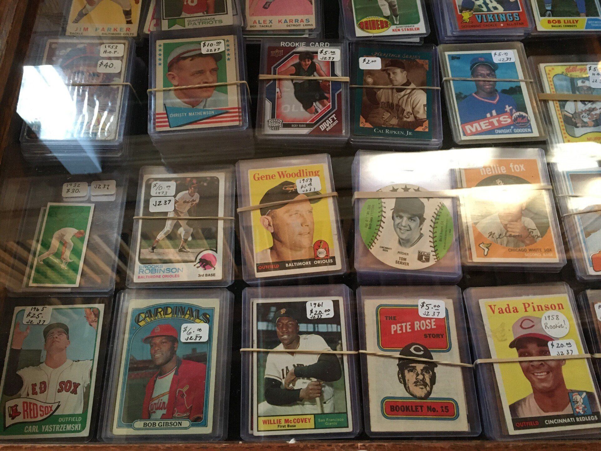 A bunch of baseball cards are stacked on top of each other