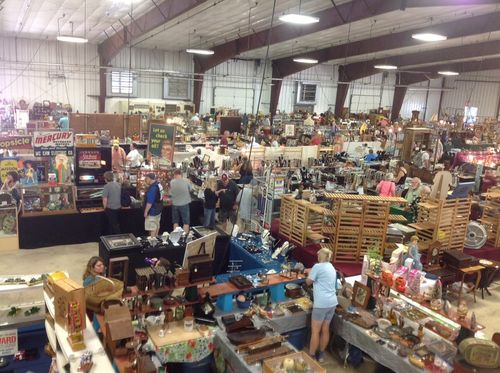 A large warehouse filled with lots of items and people