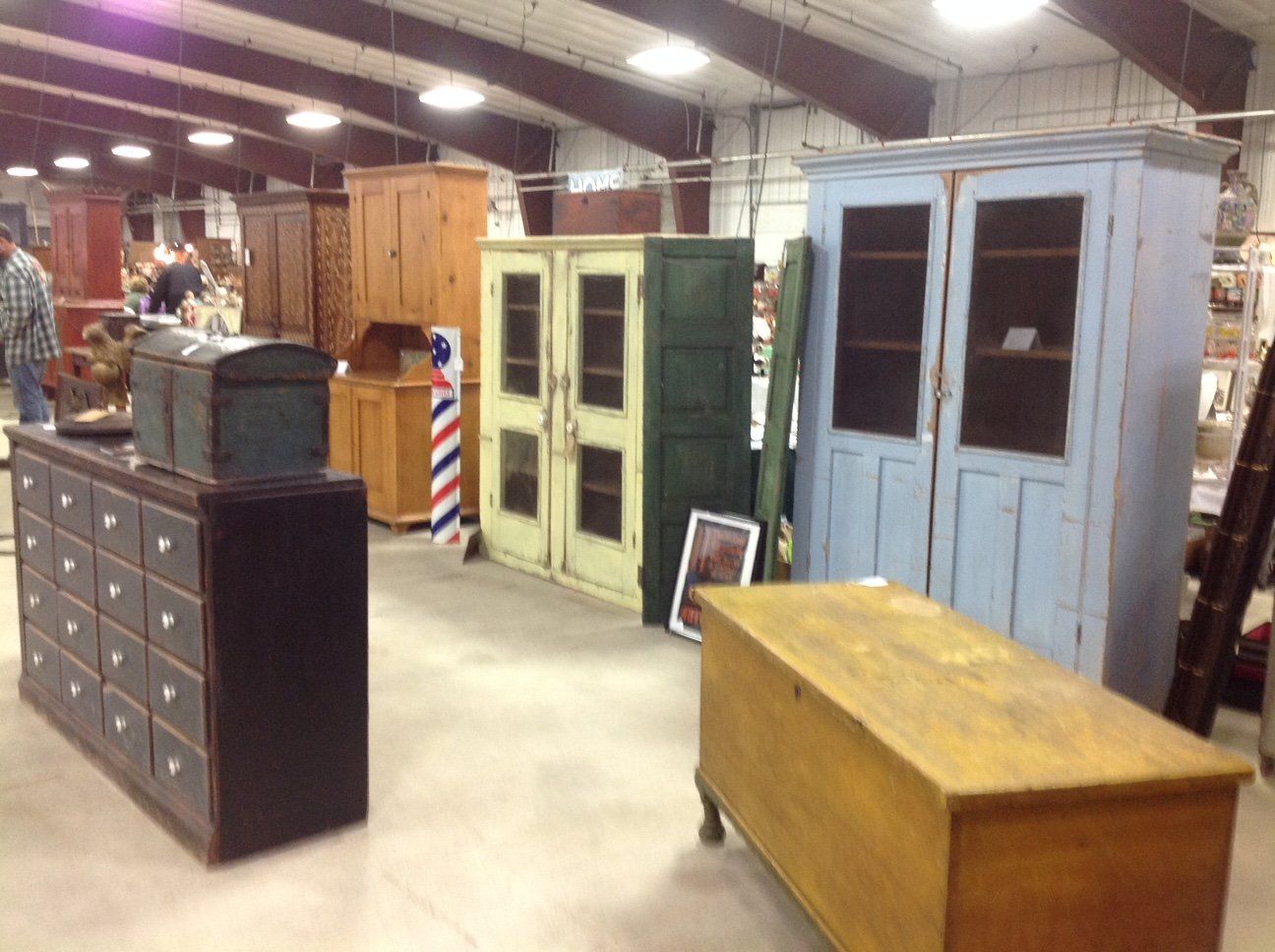 A room filled withantique furniture and a barber pole