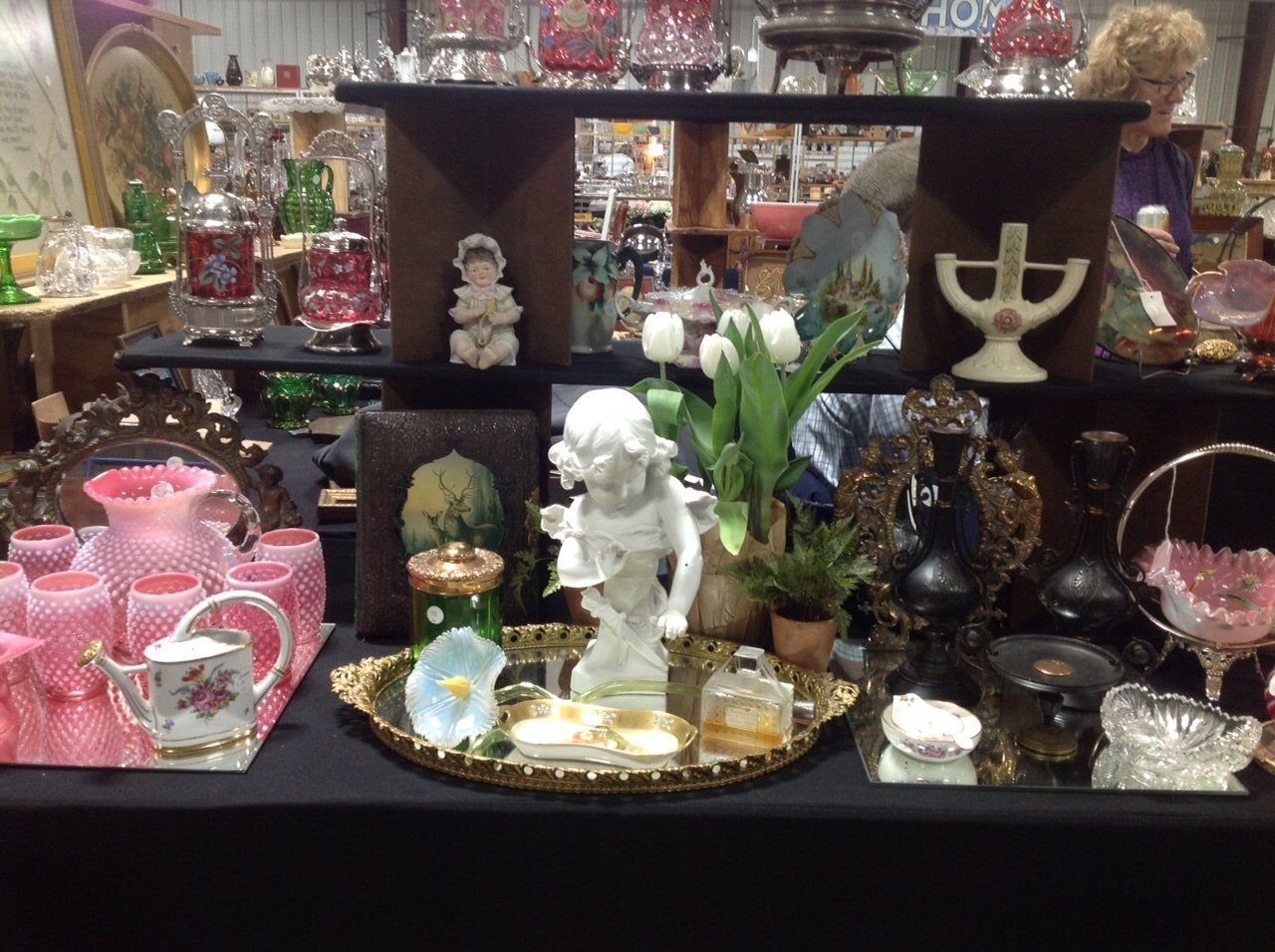 A table with a antique statue of an angel on it
