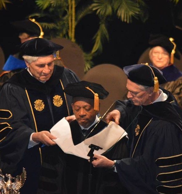 A group of graduates are looking at a piece of paper
