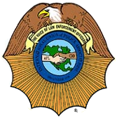 A badge with an eagle and a handshake in the middle.