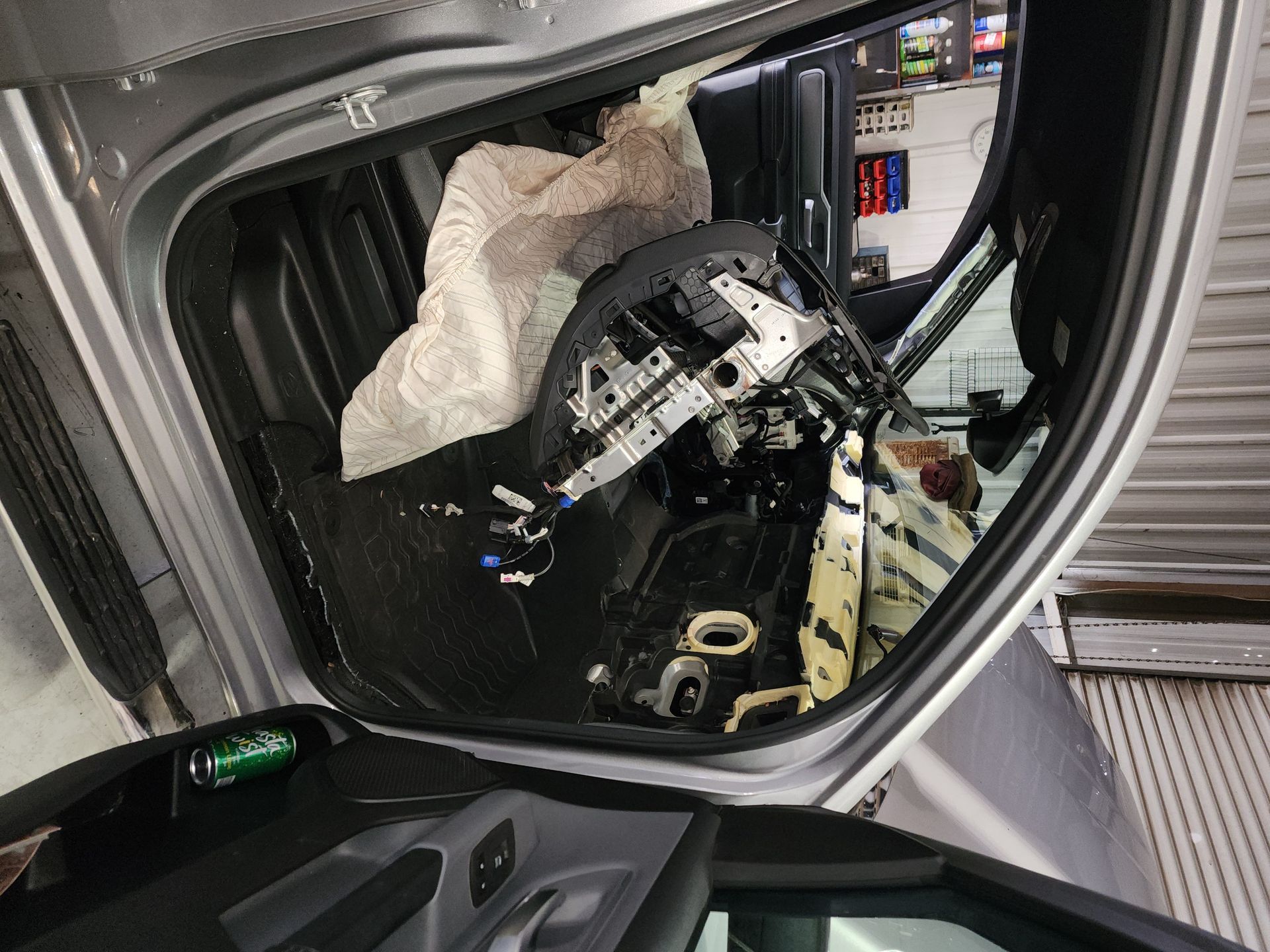 Open car trunk packed with a folded stroller and miscellaneous gear | Polar Bear Auto Care