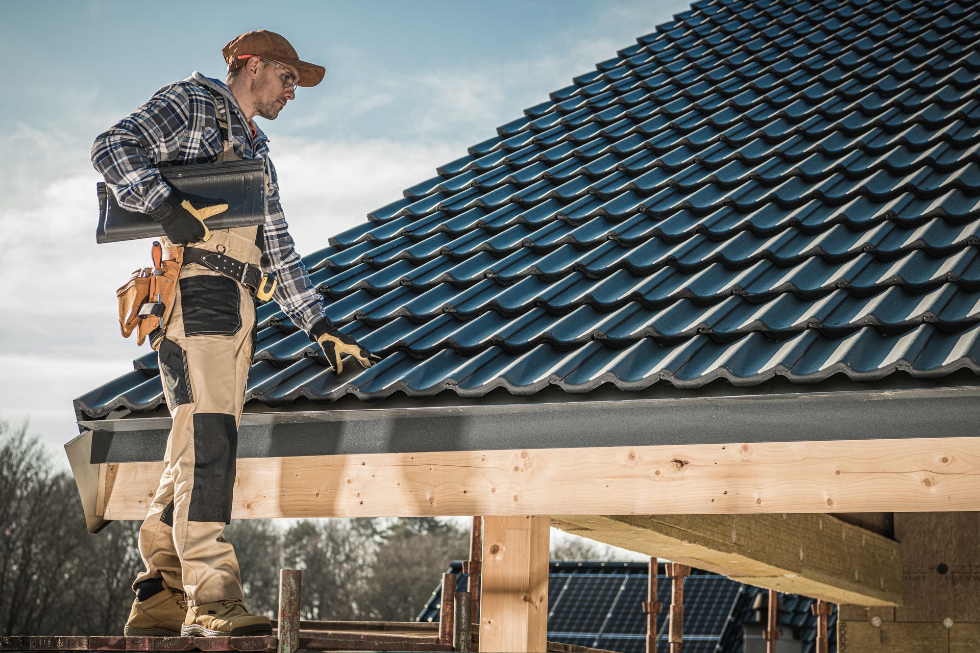 A man is inspecting a roof.