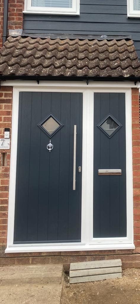 There are two doors on the side of a house.