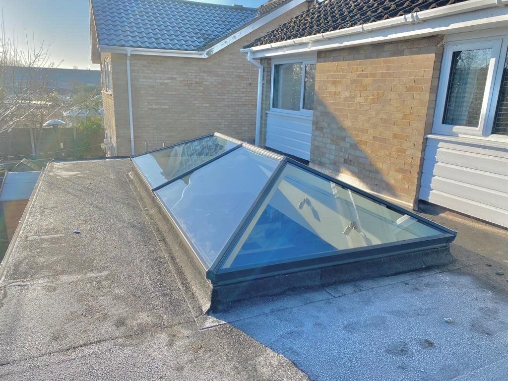 There is a skylight on the roof of a house.
