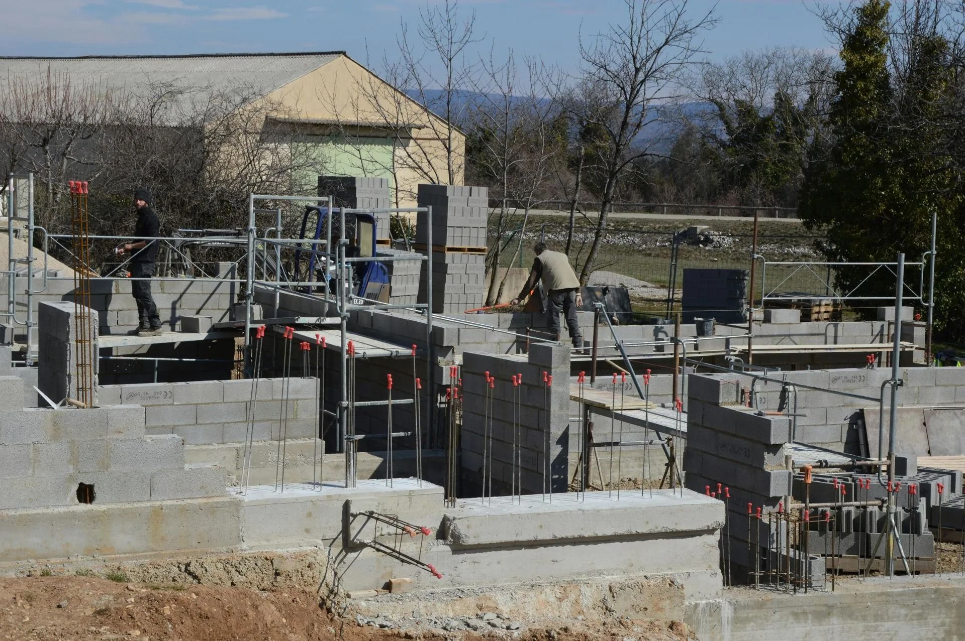 A construction site with a building in the background