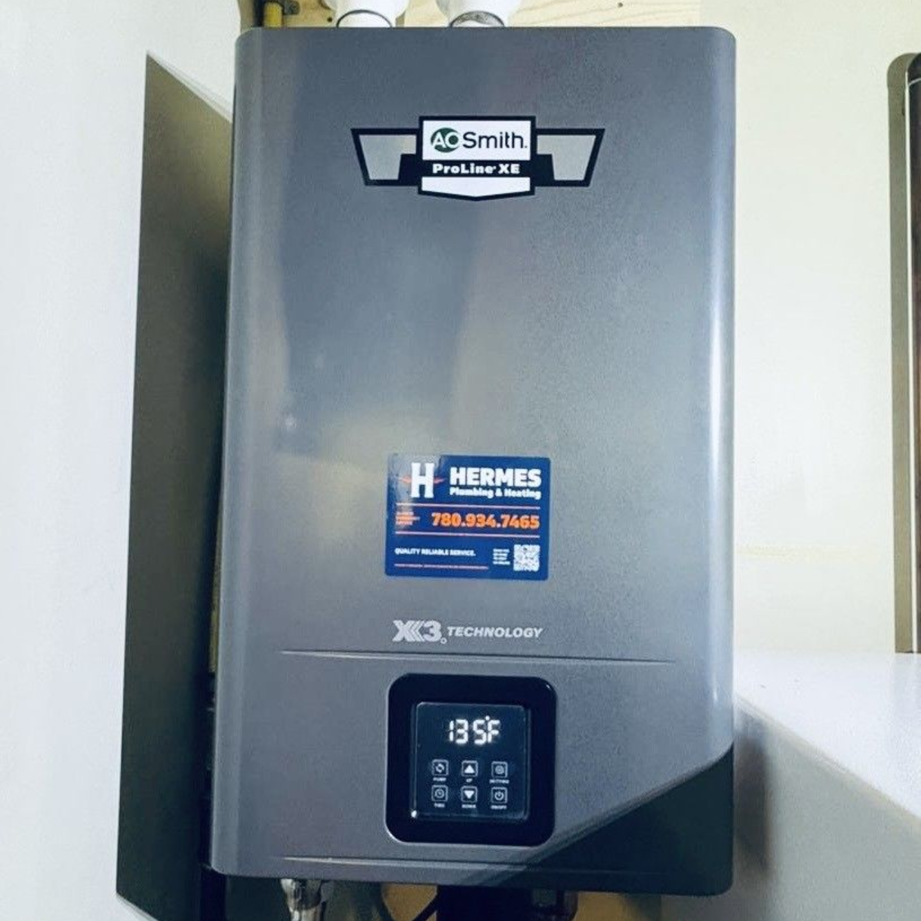 Plumber in black gloves and safety glasses repairing a water heater on a white wall.