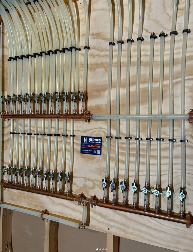 A bunch of pipes are lined up on a wooden wall