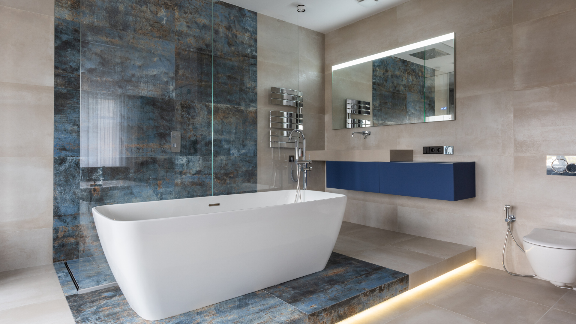 A bathroom with a bathtub , sink , toilet and mirror.