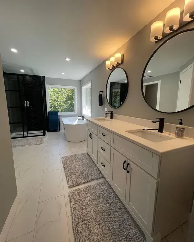A bathroom with two sinks and two mirrors