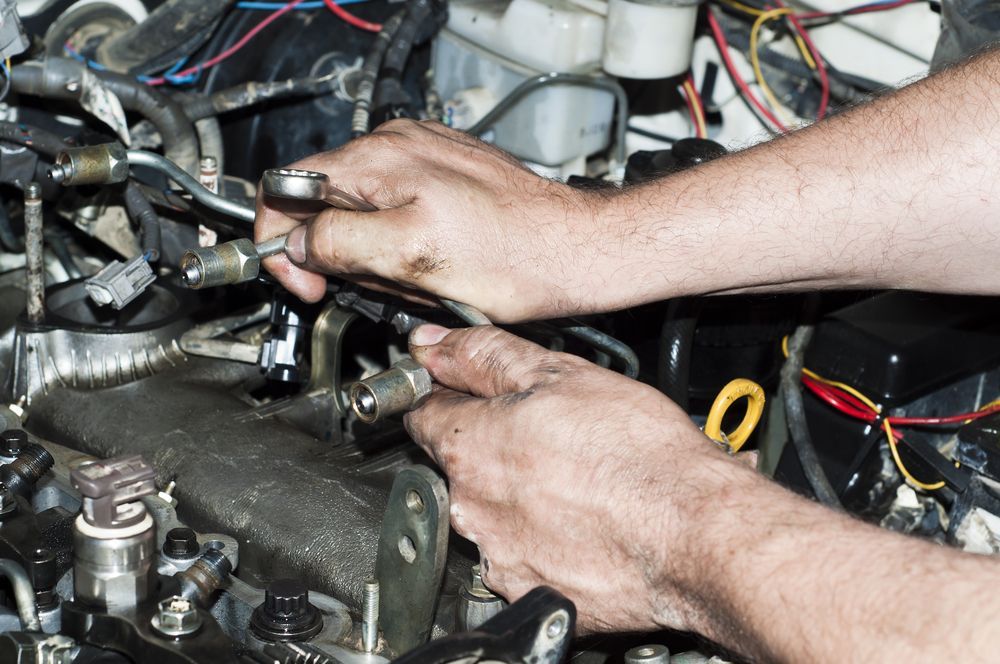 A Man is Working on a Car Engine With a Wrench — Tamworth Manual Transmission Factory in Scone, NSW