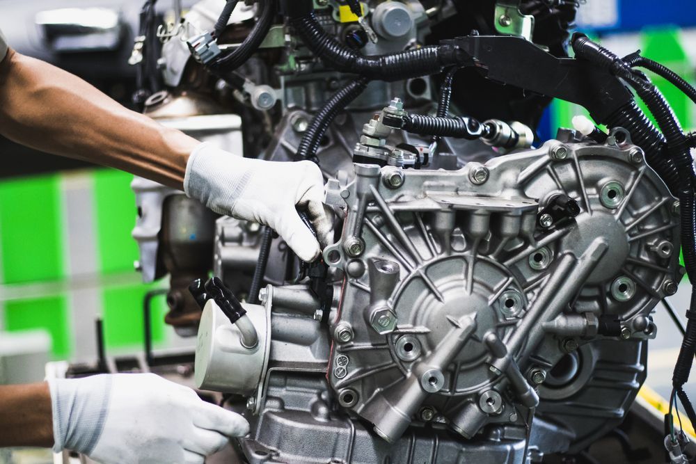 A Man is Working on a Car Engine in a Factory — Tamworth Manual Transmission Factory in Scone, NSW