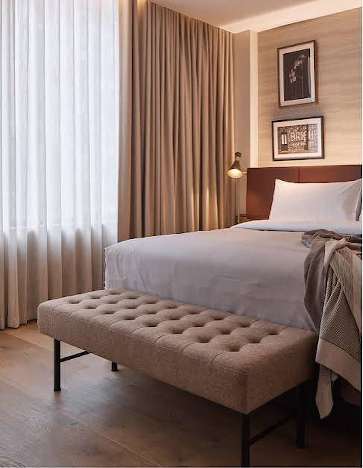Neatly Made Bed With Tufted Bench in a Warm, Modern Bedroom — Citrus Clean Central Coast in Charmhaven, NSW