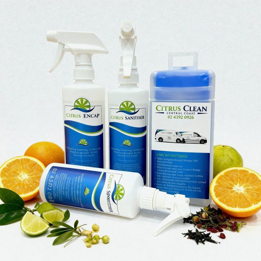 Four bottles of Citrus Clean cleaning products arranged with fresh citrus fruits and botanical elements on a white surface — Citrus Clean Central Coast In Lake Haven, NSW