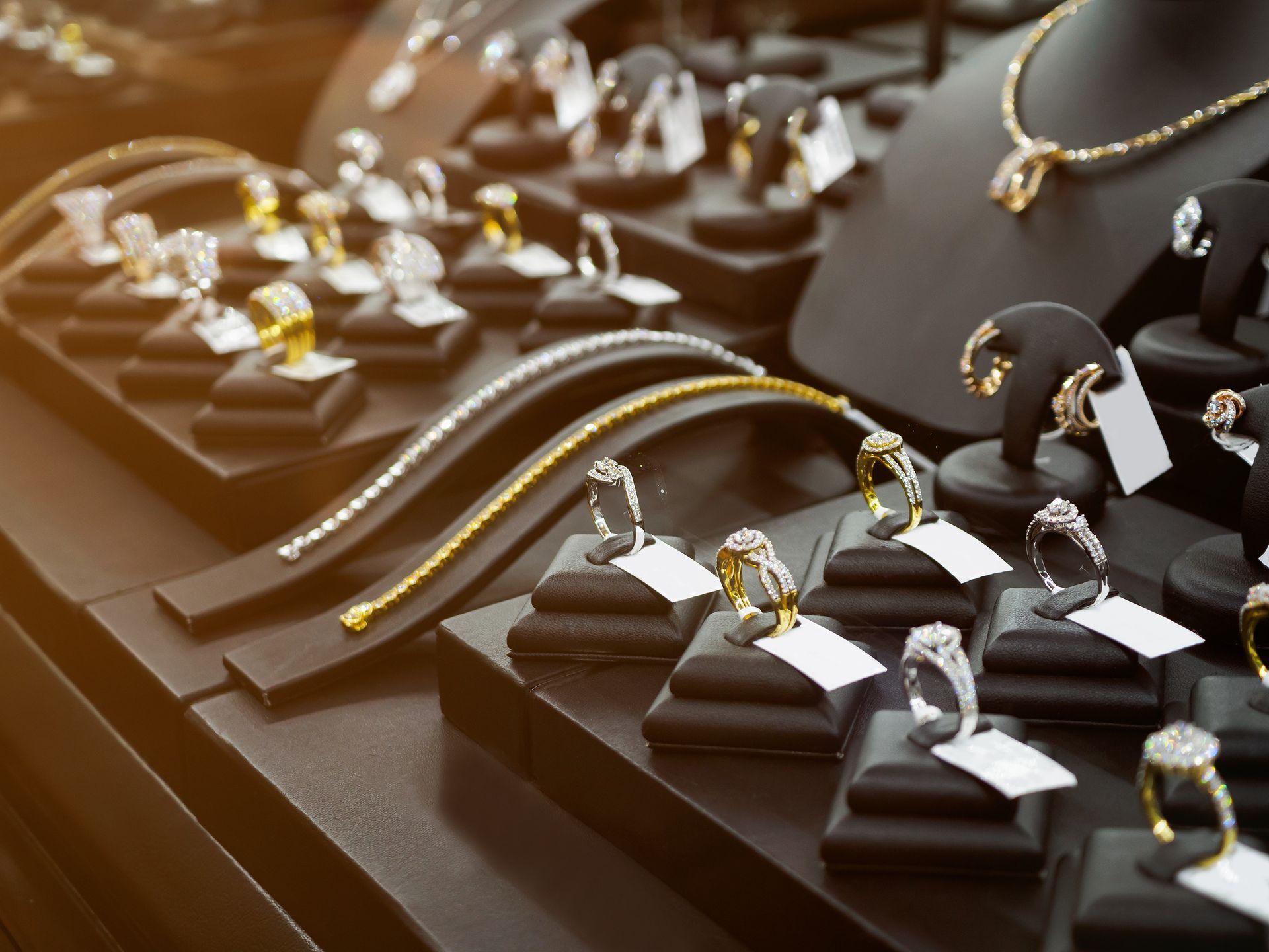 Gold jewelry diamond shop with rings and necklaces luxury retail store window display.