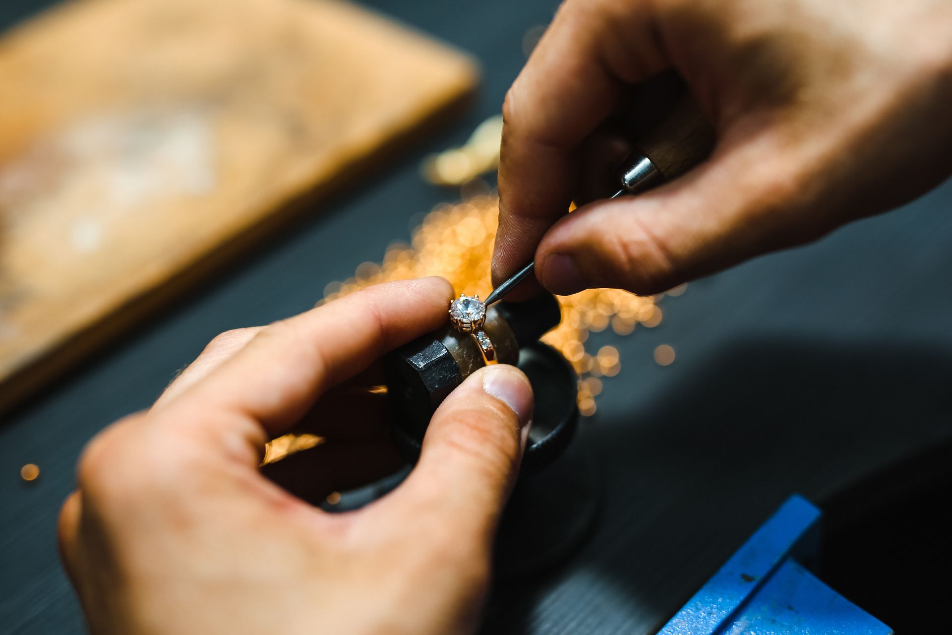 Master goldsmith working at golden ring.