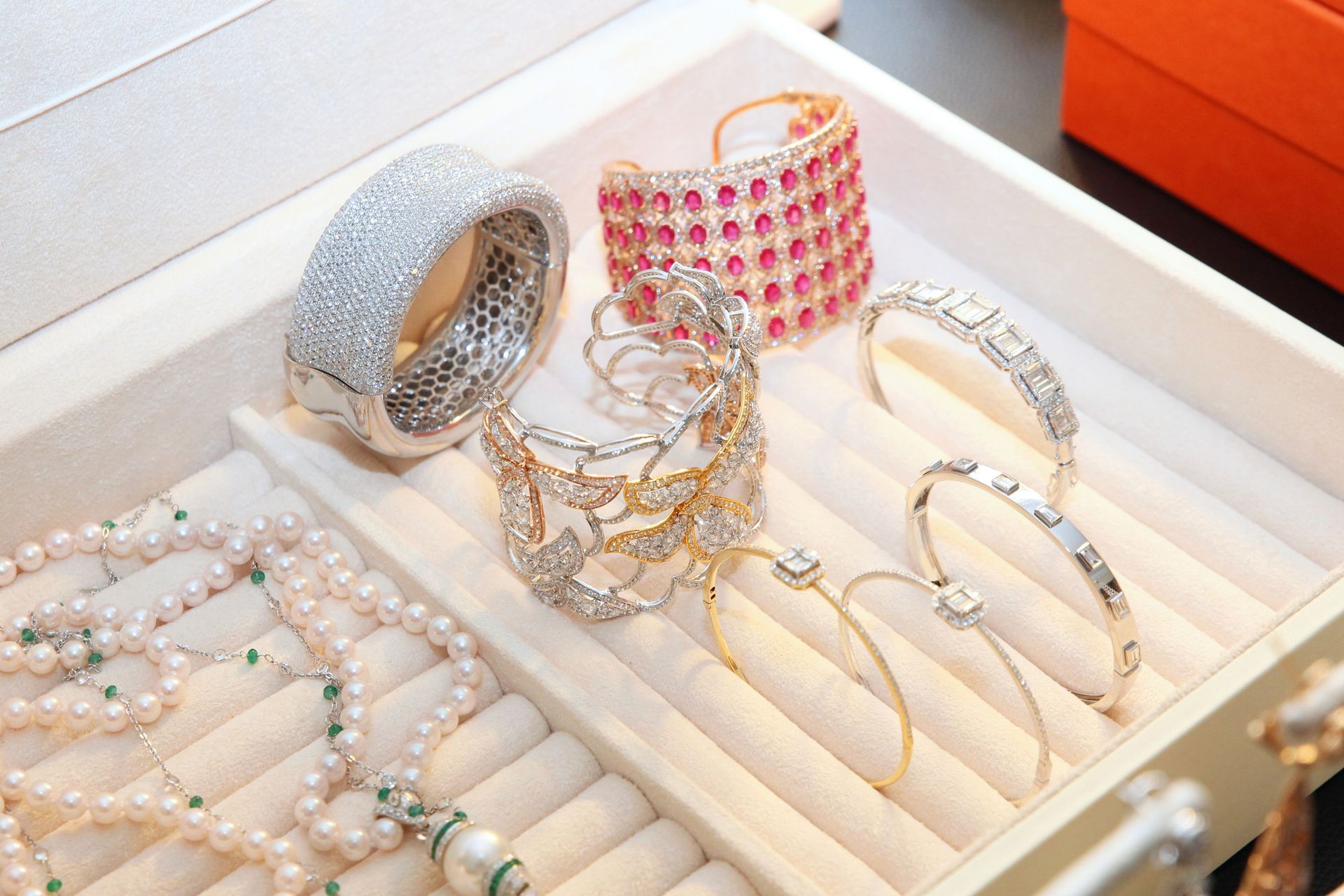 Pile of colorful stone bracelets with diamonds and pearls, showcasing fine jewelry elegance. Pile of colorful stone bracelets with diamonds and pearls, showcasing fine jewelry elegance.