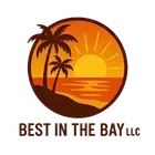 Sunset over ocean with palm trees, within a brown circular frame. 