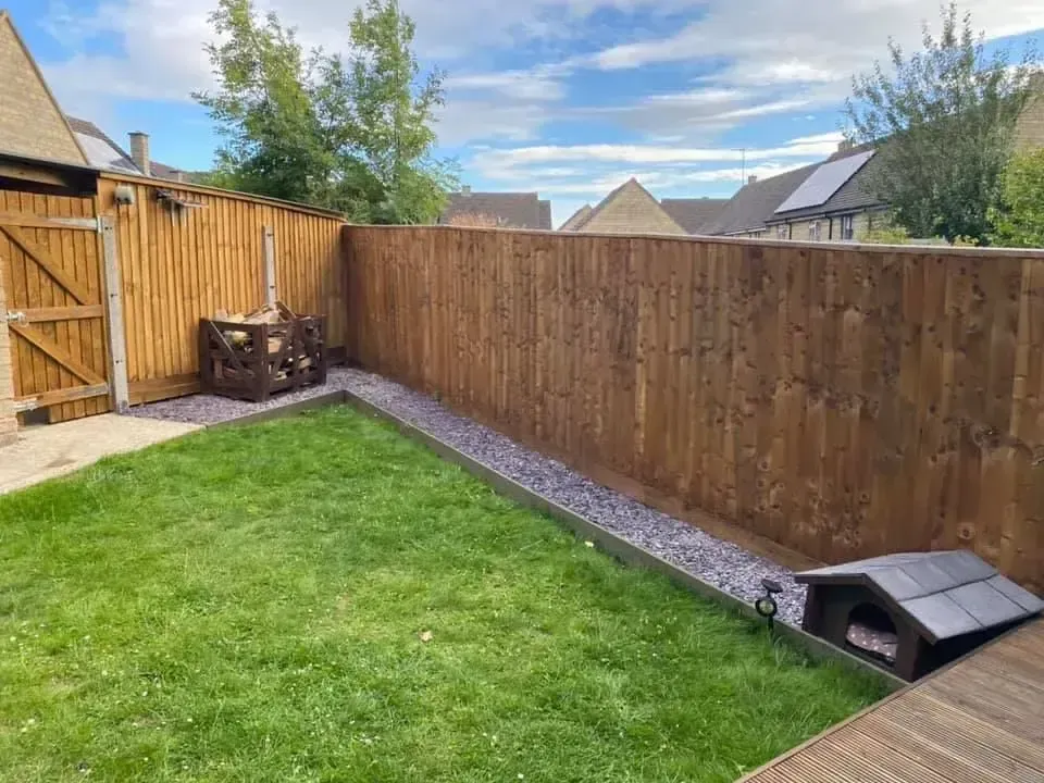 Custom closeboard timber fence installation with decorative slate border in a Morningside back garden