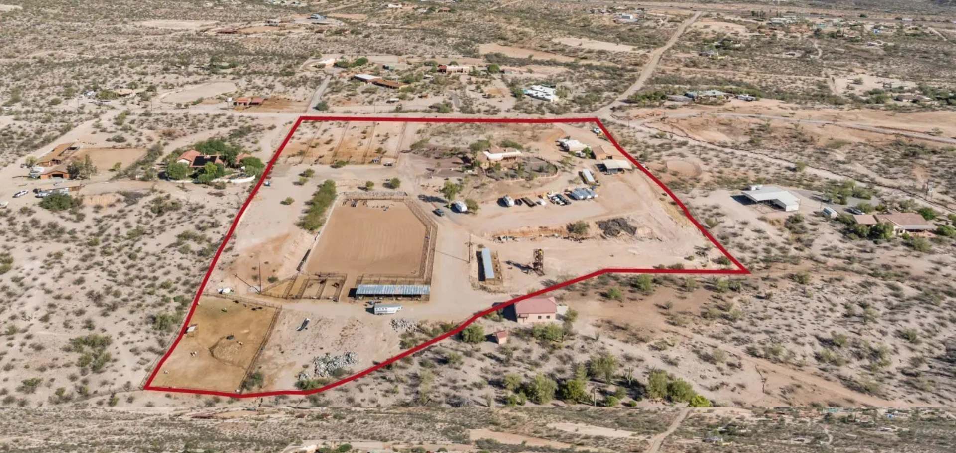 An aerial view of a desert home with a gravel driveway shaped into a heart.