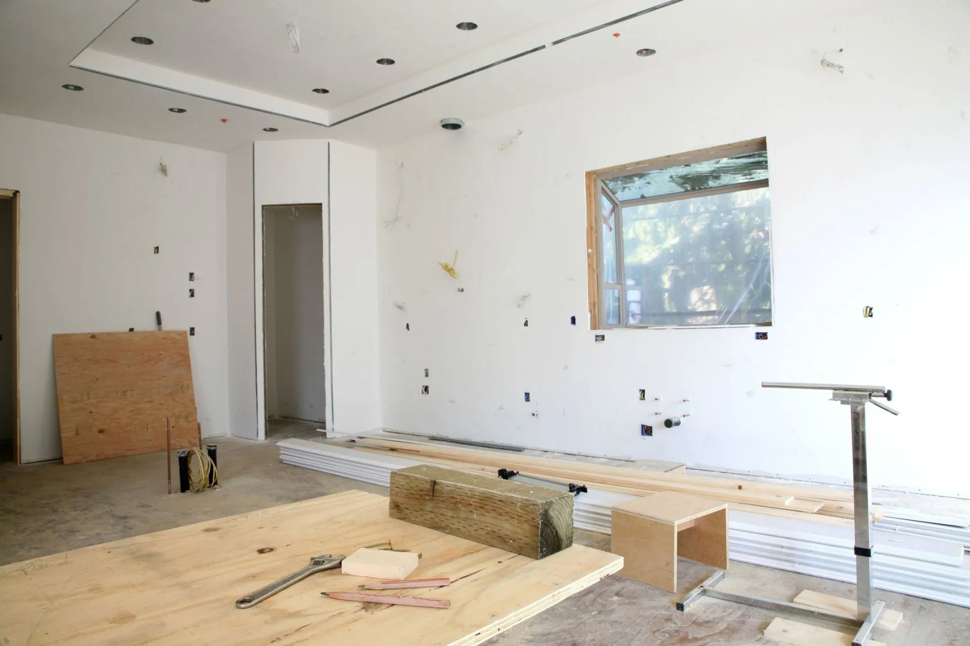 An empty room with a wooden table and a window