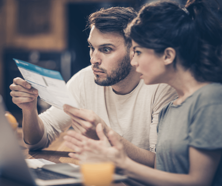 Man looking very surprised by a invoice or quote