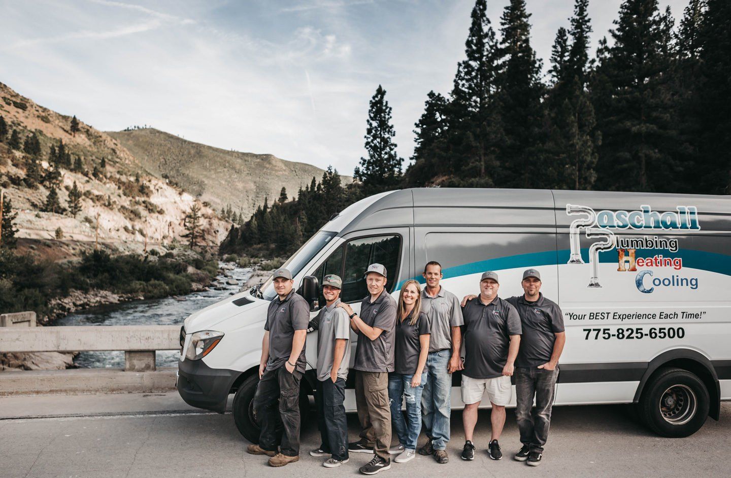 Paschall Plumbing technicians and staff in front of a company van