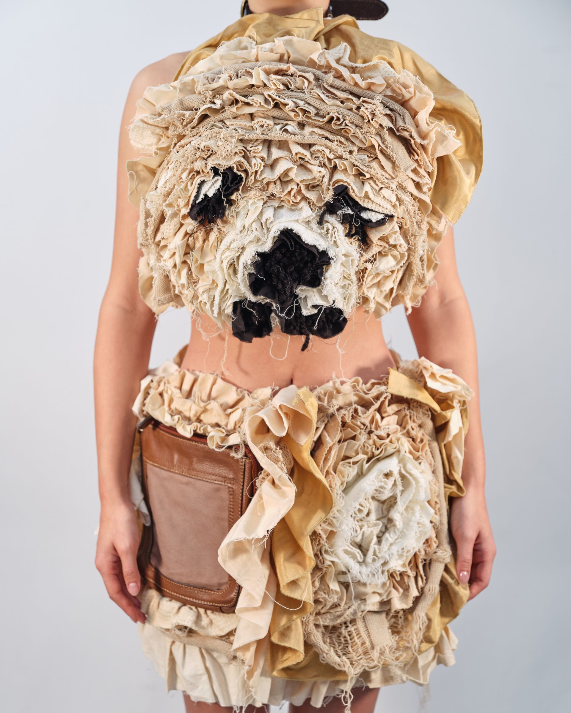 A woman is wearing a top with a dog face on it
