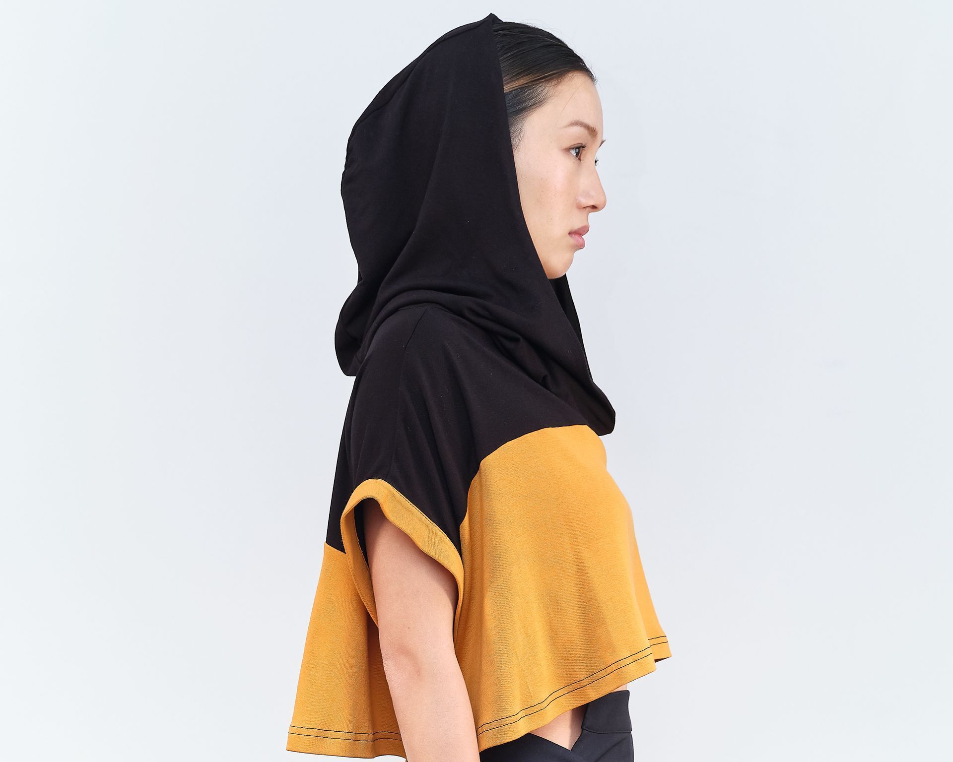 A woman wearing a black and yellow crop top