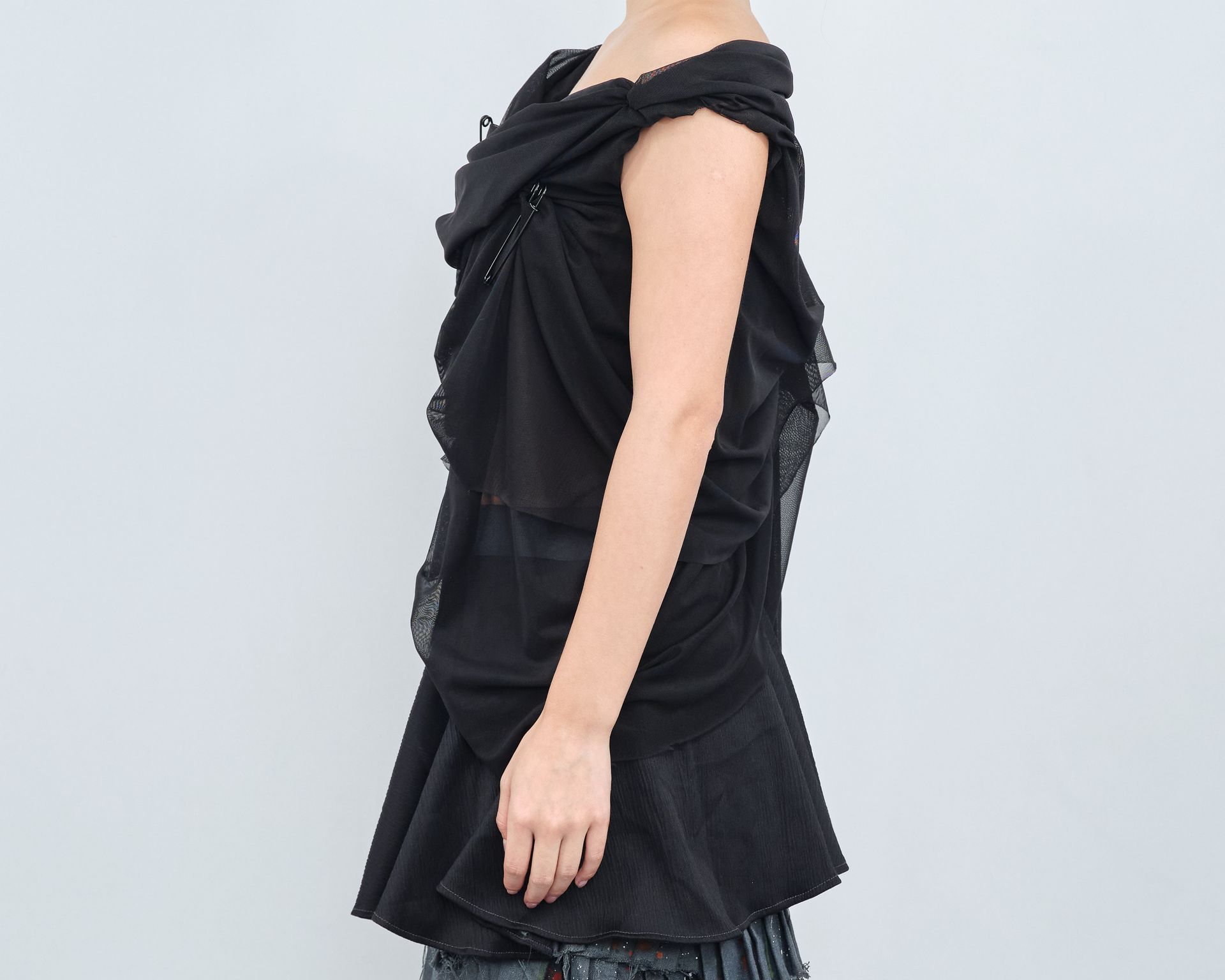 A woman is wearing a black top and jeans