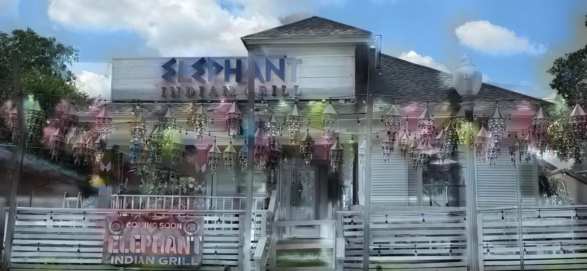 A white building with a gate and a sign that reads